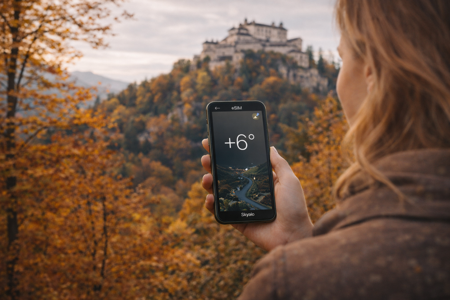 Checking the temperature near Hohensalzburg Fortress via a smartphone with an eSIM for traveling in Austria
