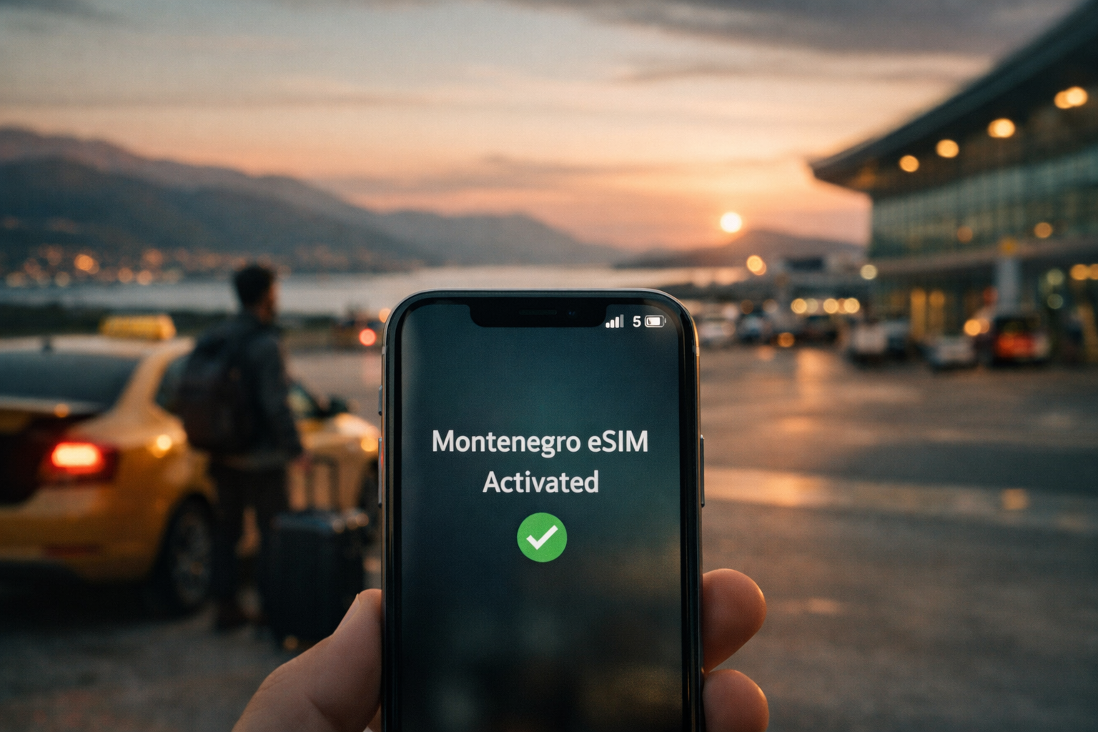 A smartphone with the text “Montenegro eSIM Activated” at the airport at sunset