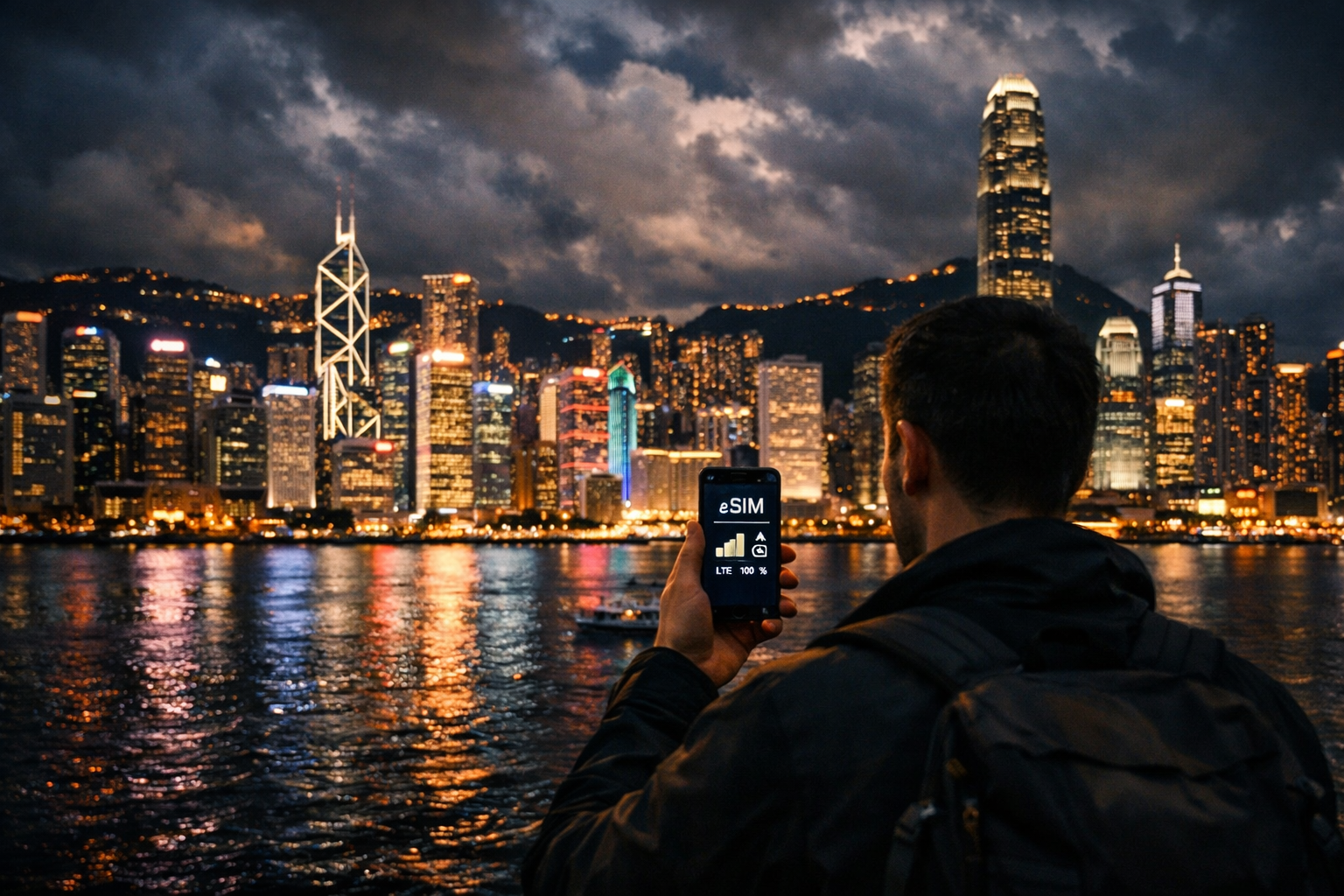 Hong Kong night skyline and a tourist with a smartphone with an activated eSIM