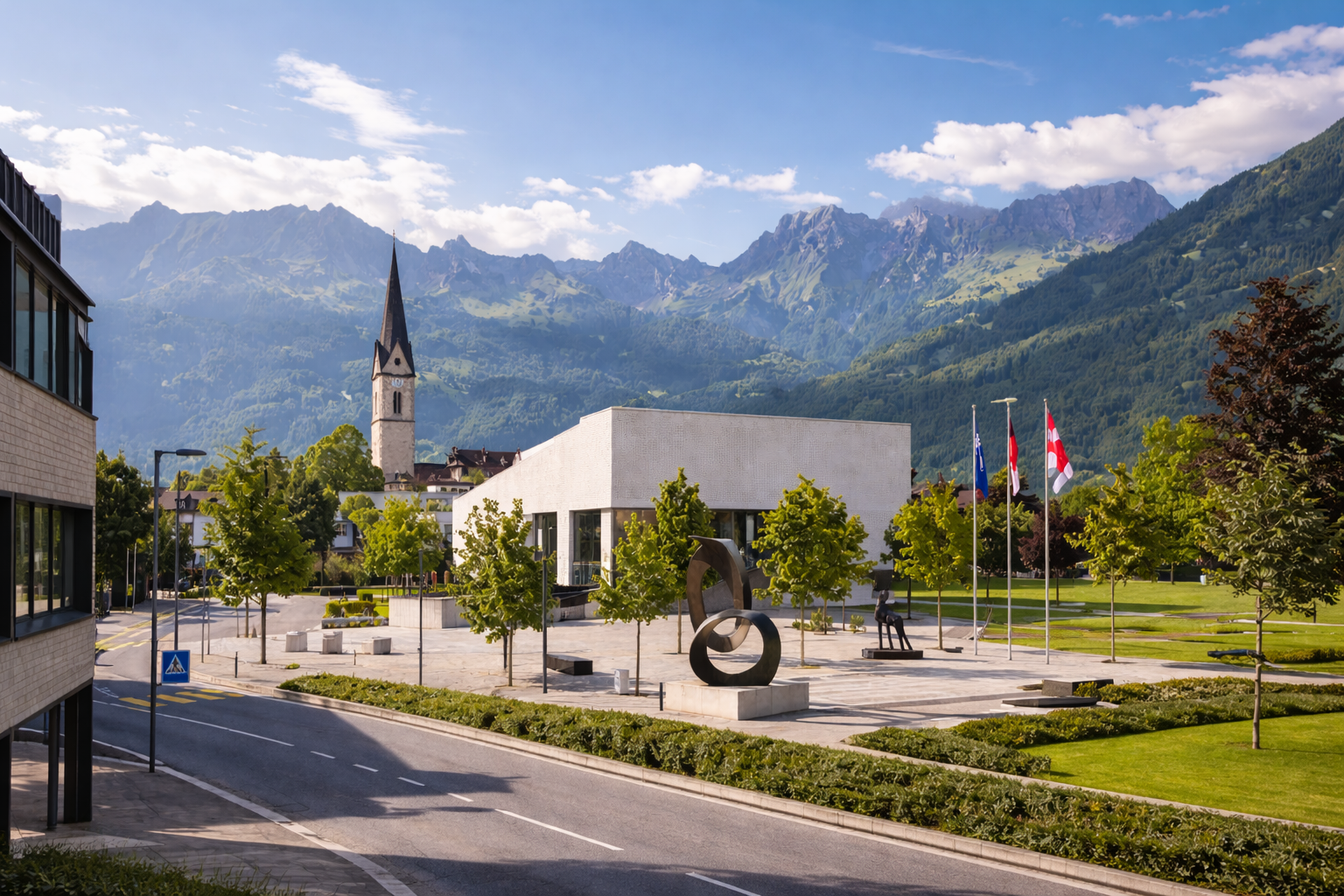 Schaan with modern buildings, green areas, and the Alps surrounding the town